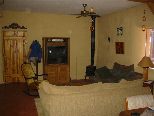 Living Room with wood stove. This little stove is all the heat that is needed for an Arizona winter. It takes the chill out of the air, and with the strawbale construction the heat is retained nicely.
