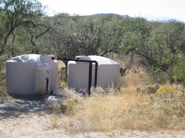 Two tanks that collect the water from the roof of the house and carport.